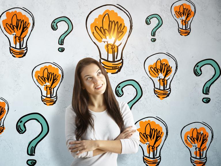 Woman on Concrete Background with Drawn Light Bulbs and Question Marks